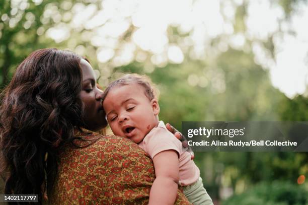 mother holding her baby - yawning mother child stock pictures, royalty-free photos & images