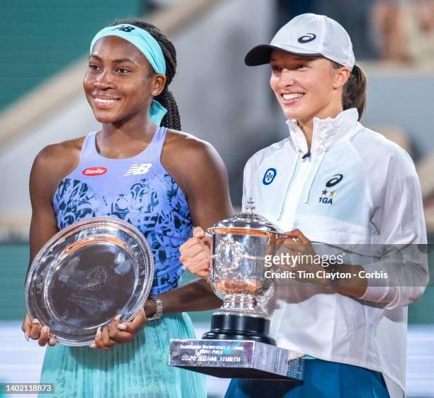Coco Gauff of the United States with the runners up trophy and Iga Swiatek of Poland with the winners trophy at the trophy presentation ceremony...