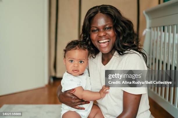 young mother with playing her baby daughter - showus family stock pictures, royalty-free photos & images