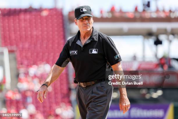 Umpire Angel Hernandez walks across the field in the eighth inning of the game between the Arizona Diamondbacks and the Cincinnati Reds at Great...