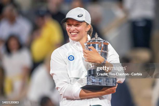 Iga Swiatek of Poland with the winners trophy after her victory against Coco Gauff of the United States during the Singles Final for Women on Court...
