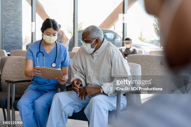 nurse helps elderly patient - coronavirus doctor stock pictures, royalty-free photos & images
