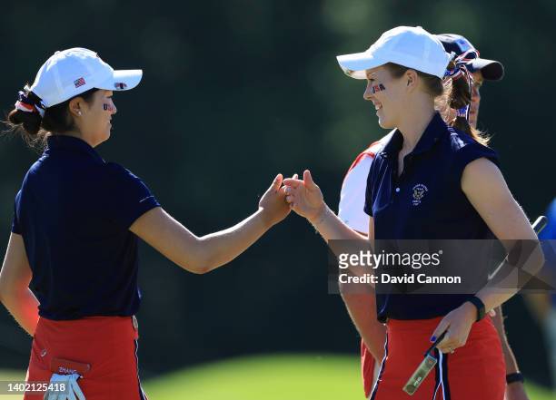 Rose Zhang of The United States team congratulates her partner Emilia Migliaccio after she had holed a winning putt for birdie on the fourth hole...