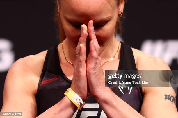 Flyweight champion Valentina Shevchenko of Kyrgyzstan poses on the scale ahead of her title defense bout against Taila Santos of Brazil during the...