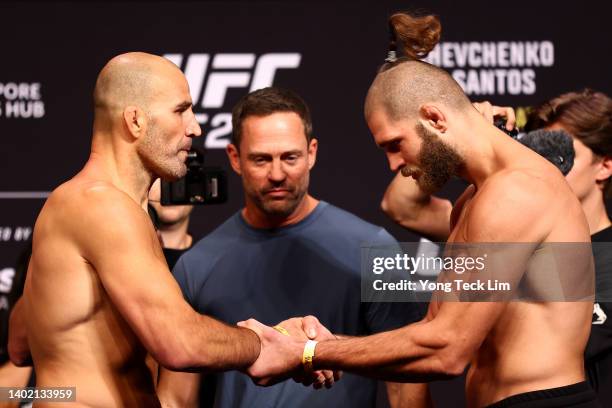 Light heavyweight champion Glover Texeira of Brazil shakes hands with Jiri Prochazka of the Czech Republic after facing off ahead of their title bout...