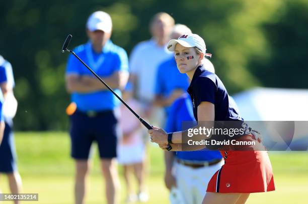 Emilia Migliaccio of The United States reacts to a putt on the first hole in her match with Rose Zhang against Louise Duncan and Charlotte Heath of...