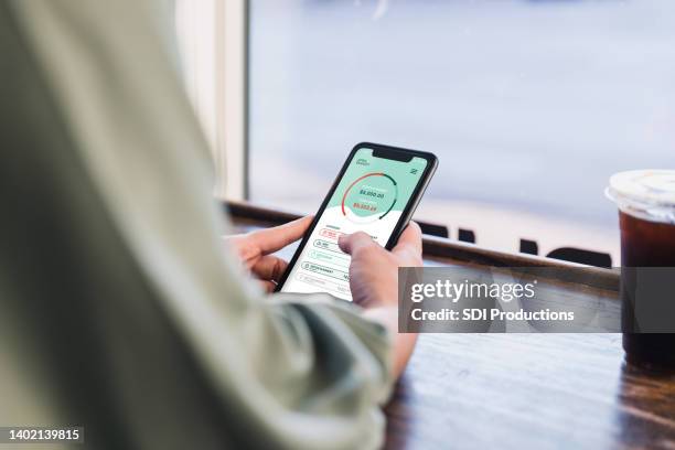 woman checks account balance on banking app - bank statement stock pictures, royalty-free photos & images