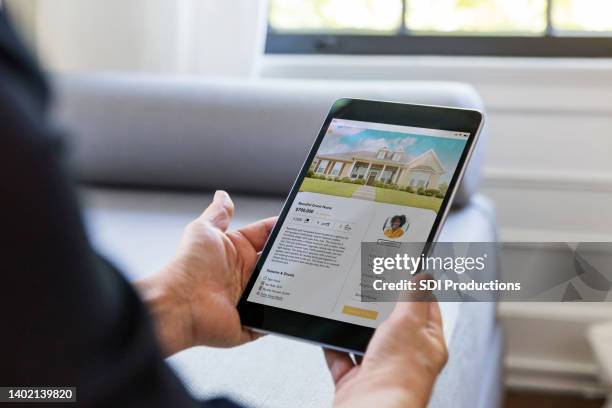 unrecognizable person looks for home using mobile app - shopping screen stockfoto's en -beelden