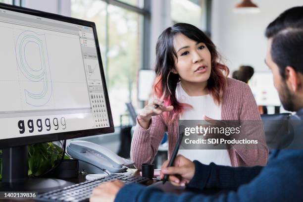 two design professionals discussing project - lettertype stockfoto's en -beelden