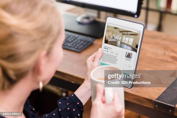 woman uses real estate app to look at home interior - search new home stock pictures, royalty-free photos & images