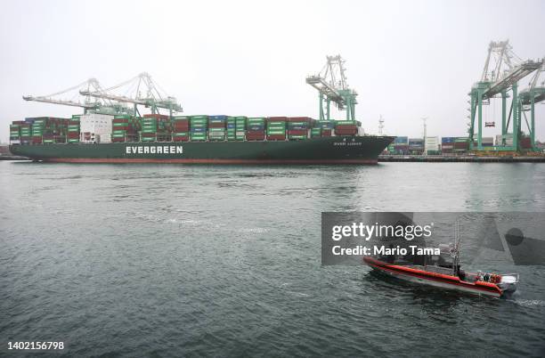Coast Guard vessel patrols in the Port of Los Angeles near a container ship before U.S. President Joe Biden delivers remarks aboard the Battleship...