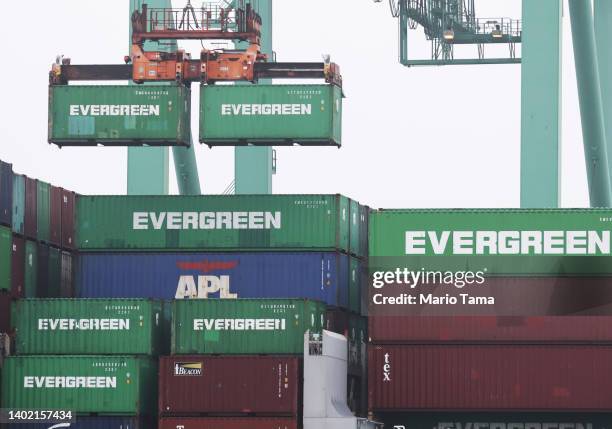 Shipping containers are offloaded from a container ship in the Port of Los Angeles before U.S. President Joe Biden delivers remarks aboard the...