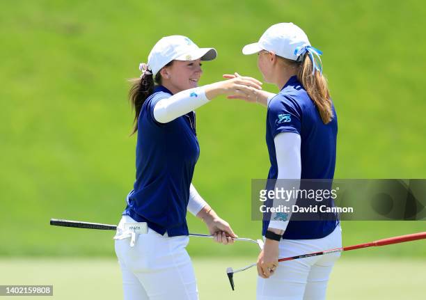 Charlotte Heath of England and The Great Britain and Ireland Team is congratulated by her partner Louise Duncan of Scotland after Heath had made a...