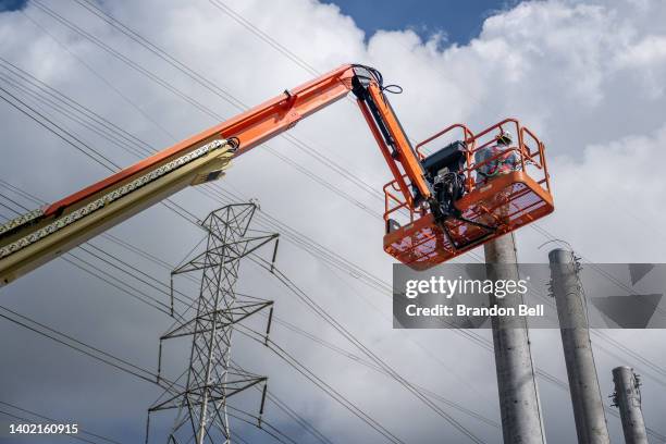 Service technicians work to install transmission towers at the CenterPoint Energy power plant on June 10, 2022 in Houston, Texas. Power demand in...