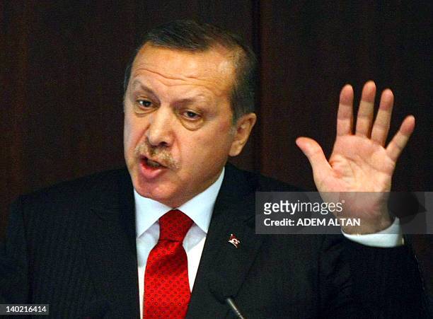 Turkish Prime Minister Recep Tayyip Erdogan speaks during a ceremony to introduce the new symbol for the national currency, the Turkish lira, in...