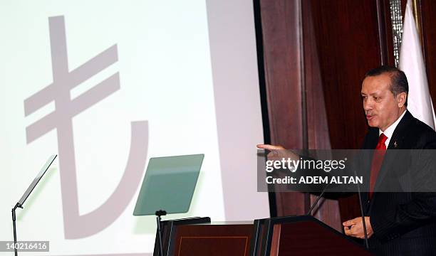 Turkish Prime Minister Recep Tayyip Erdogan speaks during a ceremony to introduce the new symbol for the national currency, the Turkish lira, in...