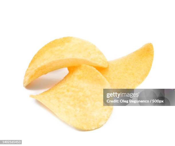 close-up of potato chips against white background,moldova - portion stock-fotos und bilder