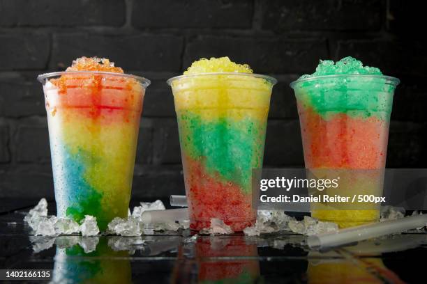 delicious row of tasty slush drinks - slushy stock-fotos und bilder