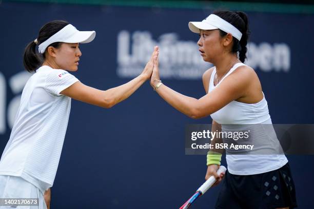 Makoto Ninomiya of Japan and Eri Hozumi of Japan celebrate a point during the Women's Doubles Quarter Finals match against Alexa Guarachi of Chili...