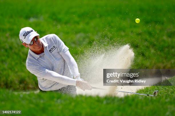 John Huston of the United States plays his shot from the bunker on the 15th hole during the second round of the RBC Canadian Open at St. George's...