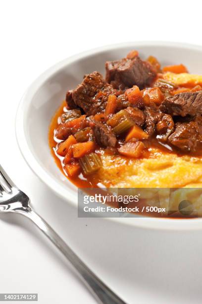 polenta and beef stew on a plate high quality photo - braised stock pictures, royalty-free photos & images