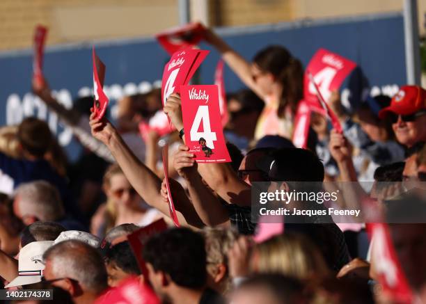 Fans hold up signs with the number 4 on them in celebration during the Vitality T20 Blast between Essex Eagles and Middlesex at Cloudfm County Ground...