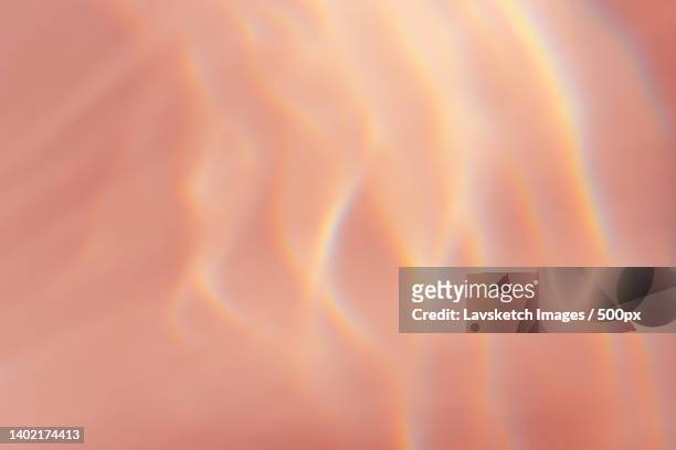 beautiful effect of sun refraction on pink background caustics - translucent glass stock pictures, royalty-free photos & images