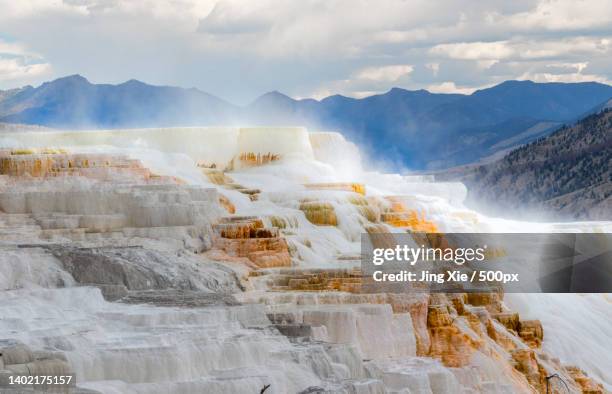 scenic view of mountains against cloudy sky - thermophile stockfoto's en -beelden