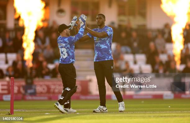 Obed McCoy of Sussex Sharks is congratulated by Tim Seifert of Sussex Sharks after bowling Glenn Phillips of Gloucestershire during the Vitality T20...