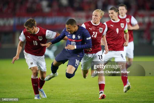 Kylian Mbappe of France is challenged by Maximilian Woeber and Xaver Schlager of Austria during the UEFA Nations League - League A Group 1 match...