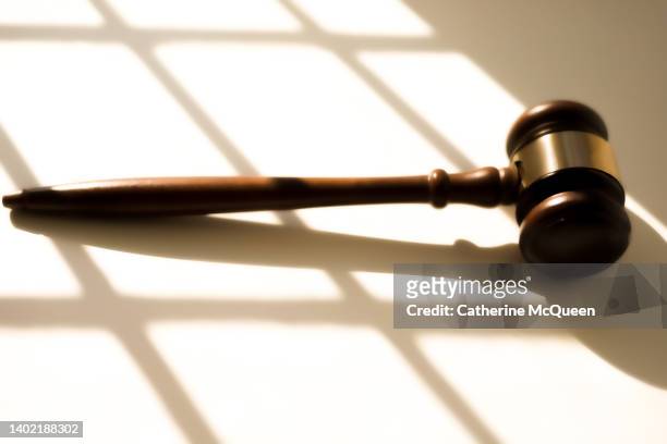 judge’s traditional wooden gavel on white background & shadow detail - verurteilung stock-fotos und bilder