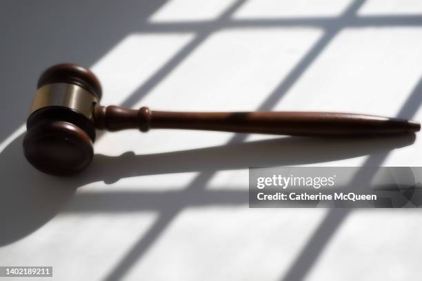 judge’s traditional wooden gavel on white background & shadow detail - supreme court hearing stock pictures, royalty-free photos & images