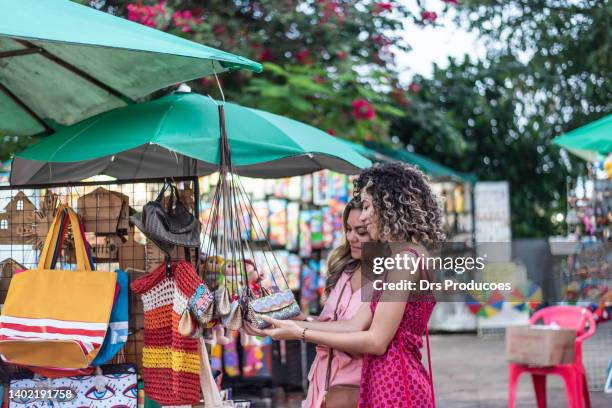 mother and daughter looking at craft store - tourism in brazil stock pictures, royalty-free photos & images