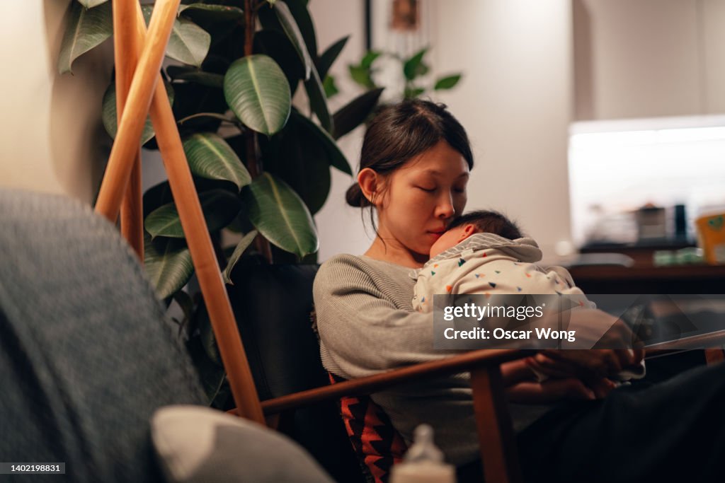 Young mother feeling stressed and exhausted with a new baby