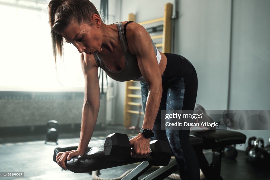 A Beautiful And Strong Athletic Woman Working Hard In Gym High-Res