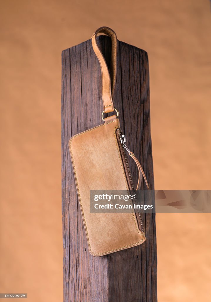 Leather wallet in an epic perspective on a wooden podium