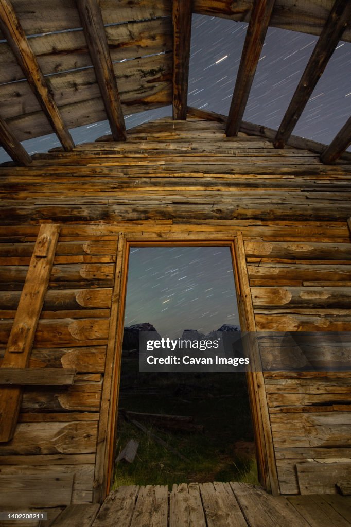 A log cabin and the beautiful mountains of the Wind River Range