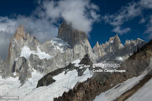 the iconic cerro fitzroy creates its own weather, often shrouded - chalten stock pictures, royalty-free photos & images