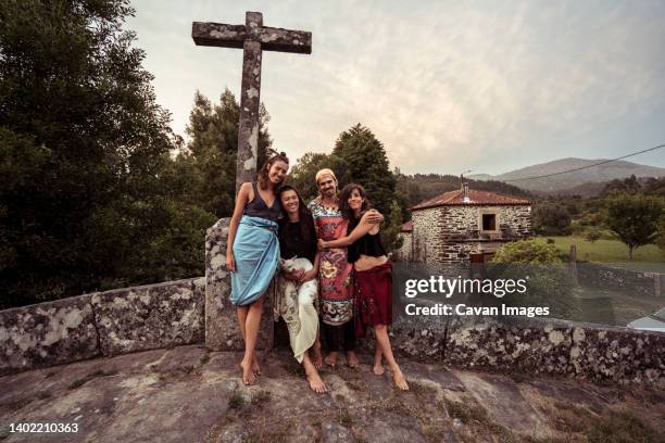 four friends and lovers hug and smile on stone bride in portugal - viana do castelo district stockfoto's en -beelden