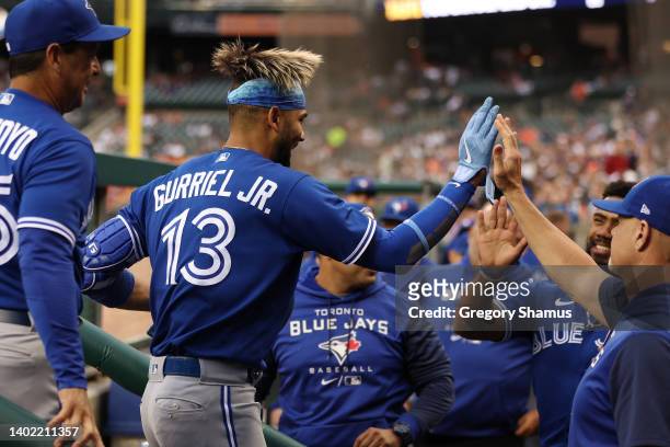 Lourdes Gurriel Jr. #13 of the Toronto Blue Jays celebrates his second inning home run with teammates while playing the Detroit Tigers at Comerica...