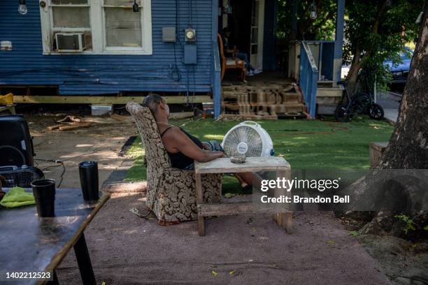 Yvette Johnson sits next to a fan outside of her families home on June 10, 2022 in Houston, Texas. Texas is under a heatwave alert as portions of the...