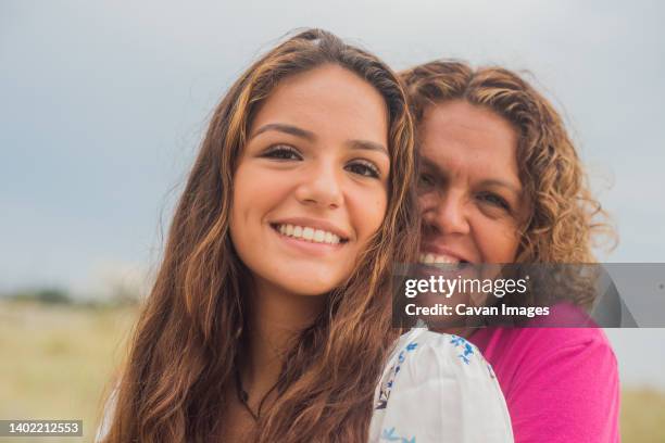 feeling alive and beautiful on the beach with mom - baby boomer millennial stock pictures, royalty-free photos & images