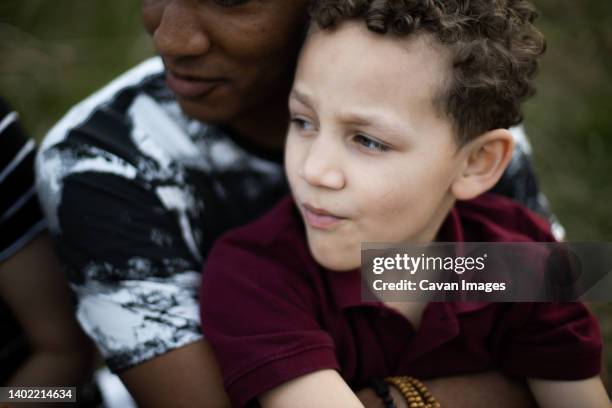 black father holds mixed race eight year old son - 40 year old black man stock-fotos und bilder