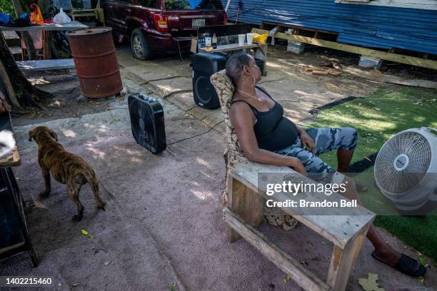 Yvette Johnson sits next to a fan outside of her families home on June 10, 2022 in Houston, Texas. Texas is under a heatwave alert as portions of the...