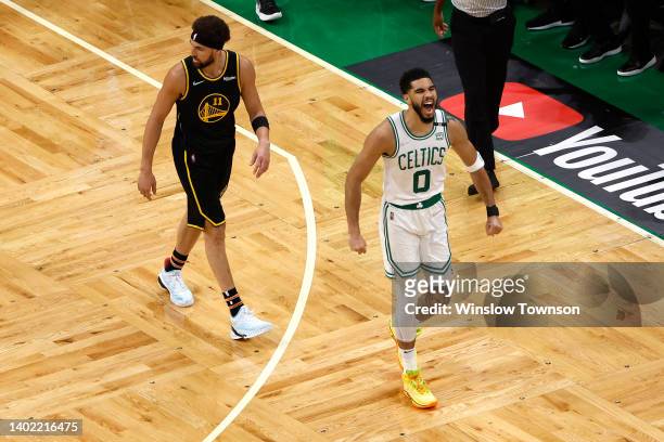 Jayson Tatum of the Boston Celtics celebrates a three point basket against Klay Thompson of the Golden State Warriors in the first quarter during...