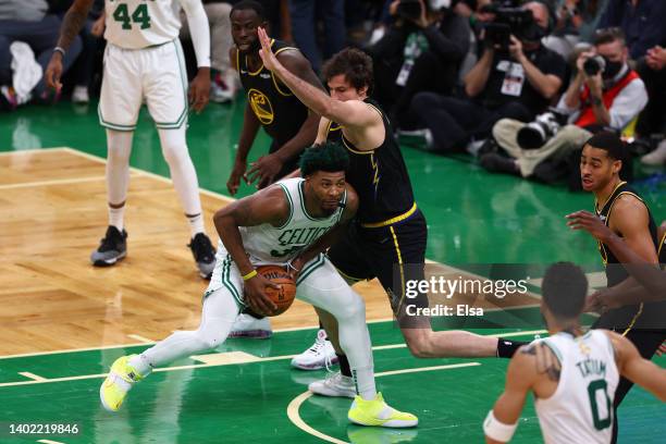 Marcus Smart of the Boston Celtics fights for position against Nemanja Bjelica of the Golden State Warriors in the second quarter during Game Four of...