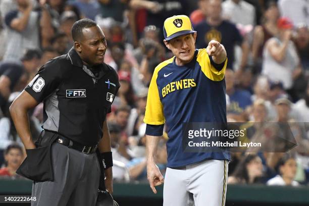 Craig Counsell of the Milwaukee Brewers agrues a call with home plate umpire Ramon De Jesus in the fifth inning during a baseball game against the...