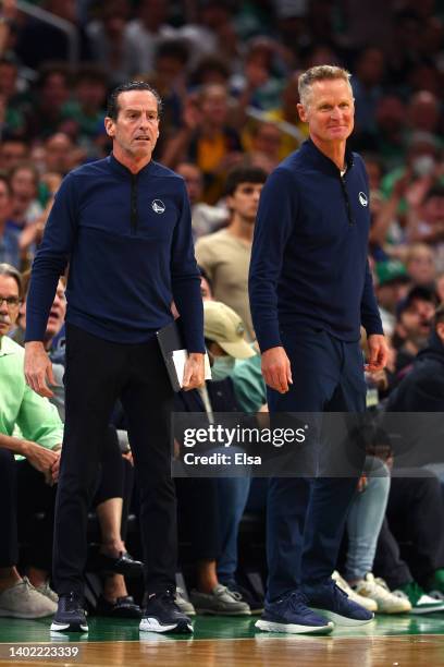 Assistant coach Kenny Atkinson and head coach Steve Kerr of the Golden State Warriors look on in the third quarter against the Boston Celtics during...