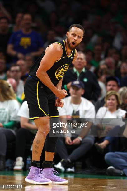 Stephen Curry of the Golden State Warriors celebrates a three point basket in the third quarter against the Boston Celtics during Game Four of the...