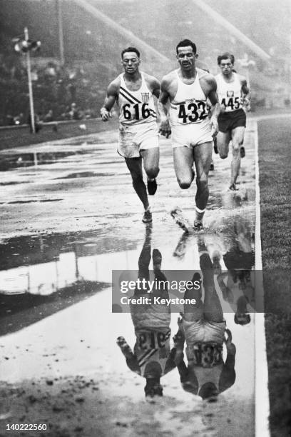 Irving Mondschein of the USA, Enrique Kistenmacher of Argentina and Edward Adamczyk competing in a men's decathlon 1500 metres heat at Wembley...